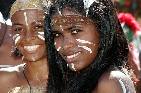Taíno women with face paint at ceremony